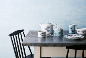 An image showing cute white and pale blue china on a marble table top
