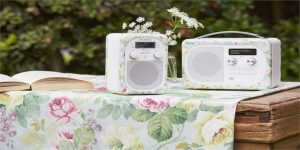 An image showing a floral speaker and radio on top of a floral table