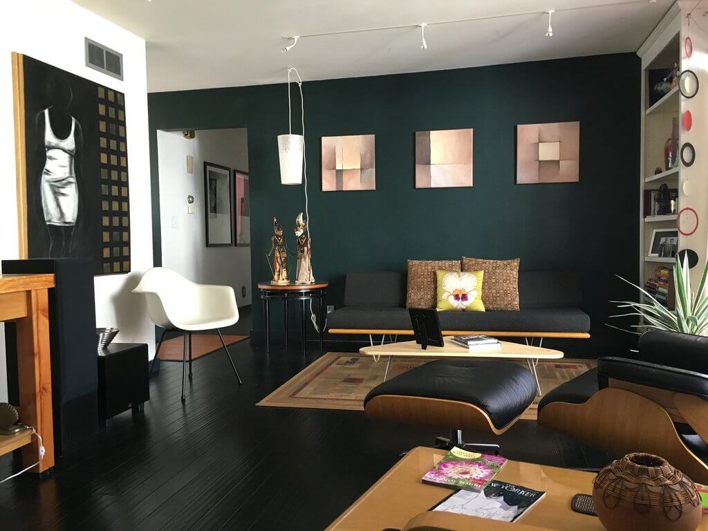 an image of of a lounge area that utilises rich, dark colours to exude a sophisticated look