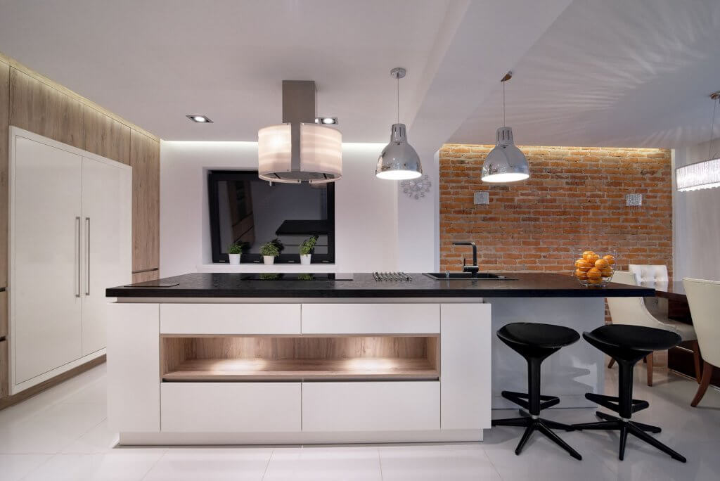 an image of a kitchen that displays plenty of different textures including marble, wood, exposed brick, and plastic